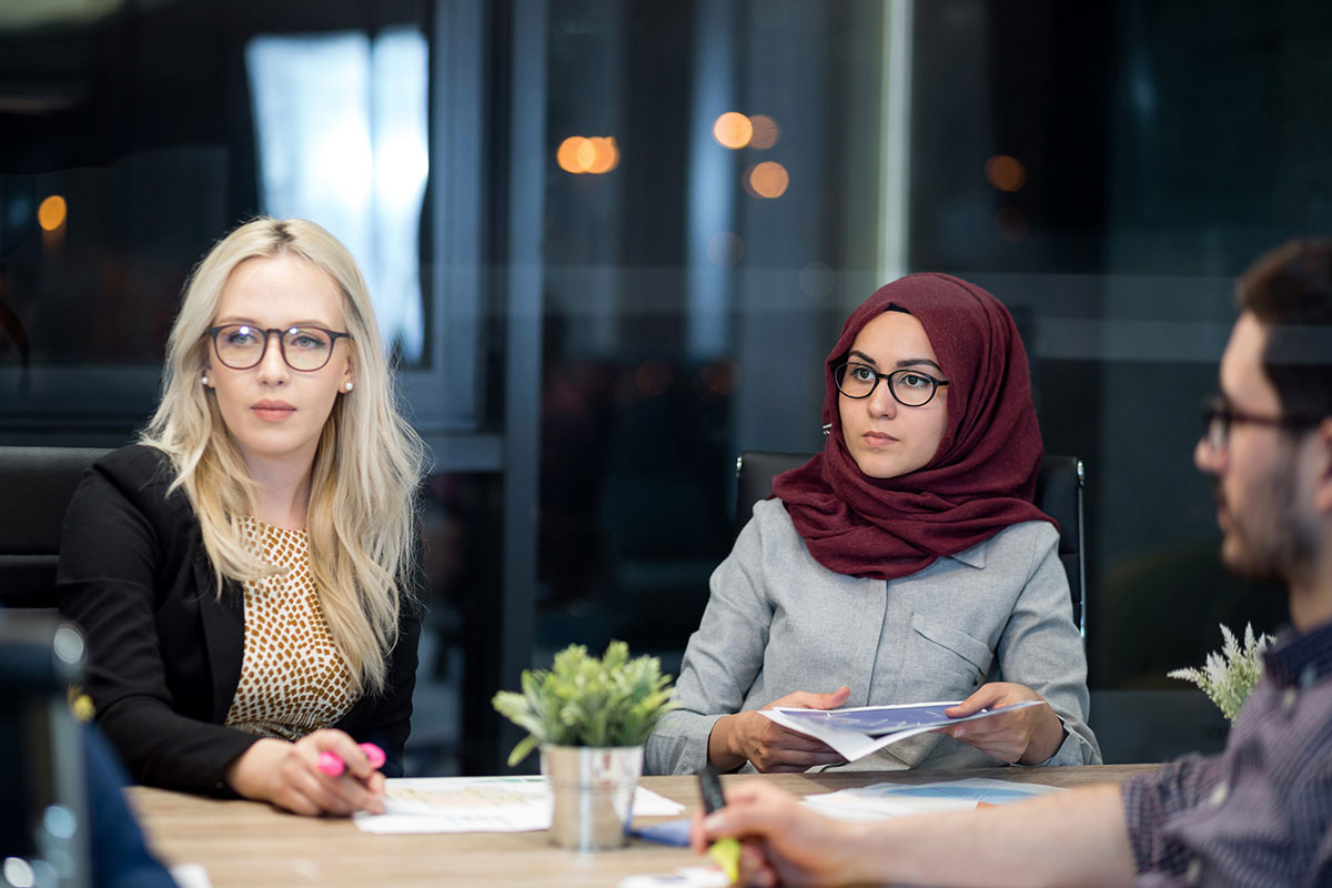 Three People Concentrating in a Meeting