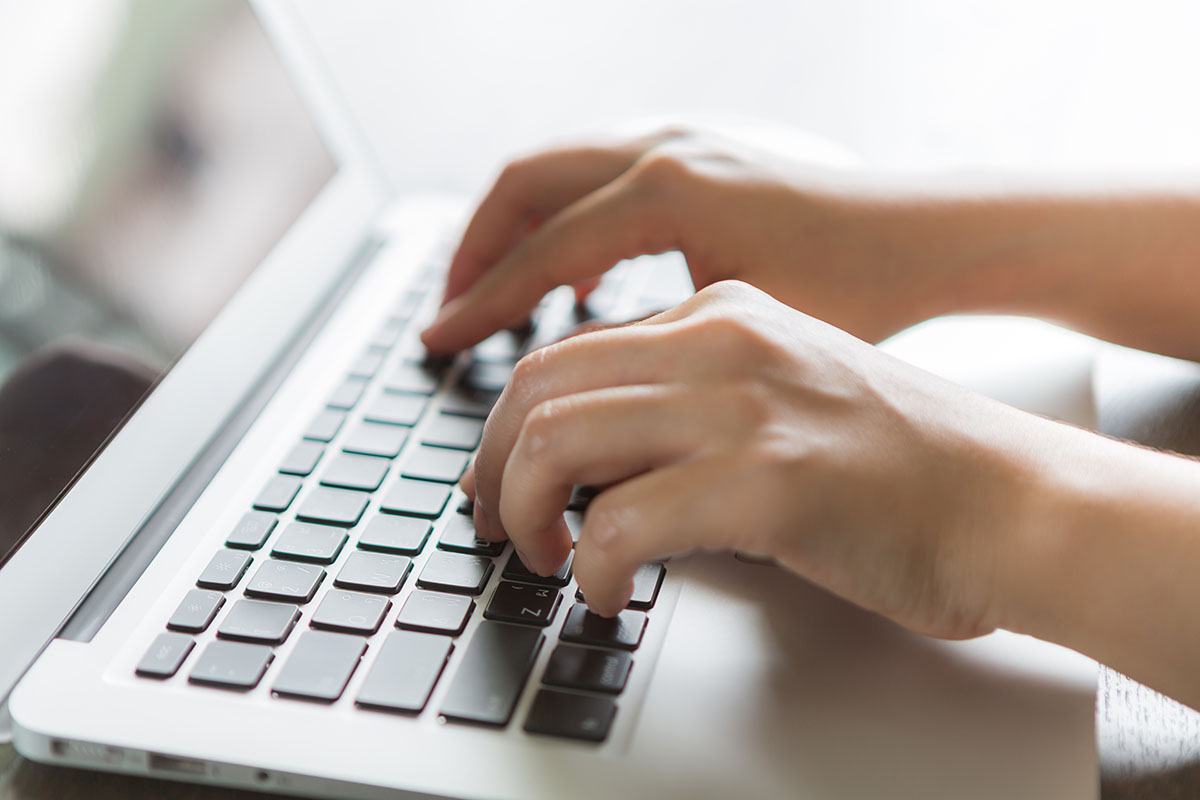 Hands Typing on a Laptop