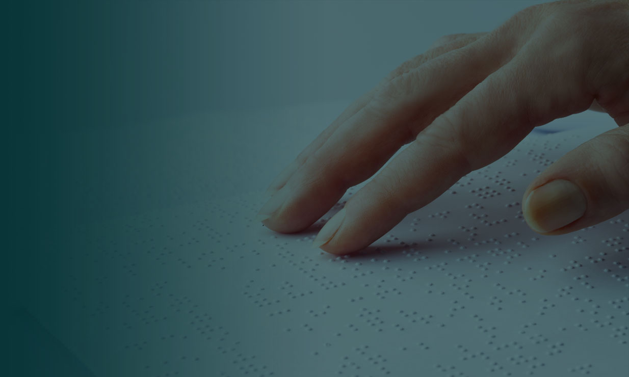 Fingers on a Braille Book page